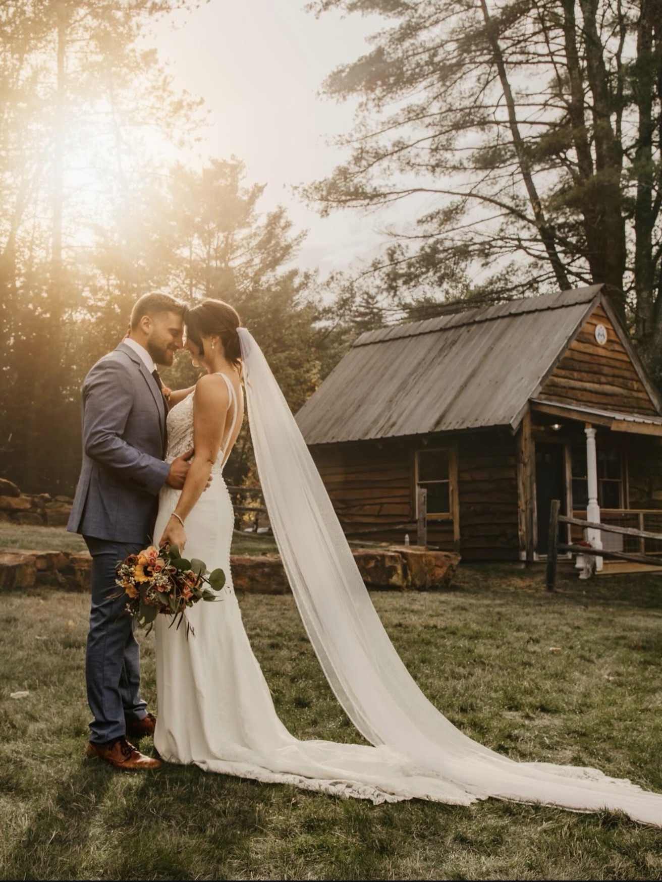 CT Bride in a wedding dress taking a photo of a groom in a suit at sunset